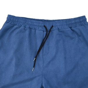 Detail of blue suede-like shorts featuring elastic waistband and black drawstrings