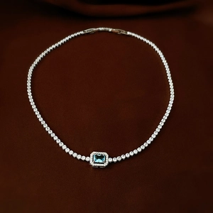 Detail of tennis choker with emerald-cut blue gemstone and pavé crystal accents