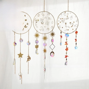 Detailed view of bohemian suncatchers with gold metal charms and faceted crystal beads