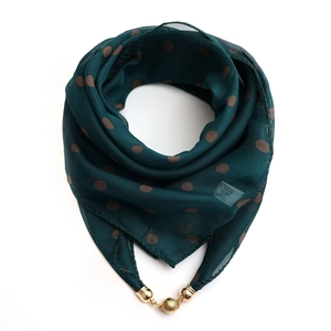 Detail of green polka dot scarf with gold magnetic buckle and polyester care label