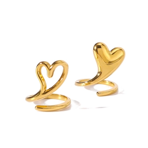 Golden stainless steel rings with solid and hollow heart designs on a spiral base