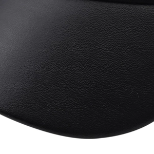 Macro shot of black litchi grain leather texture on a cotton military style beret hat