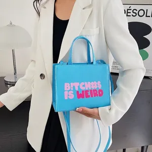 Blue PU leather square crossbody bag with pink graphic text and shoulder strap