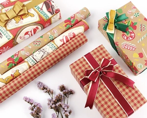 Detail of Christmas wrapping paper rolls with red plaid, Kraft, and festive bear prints