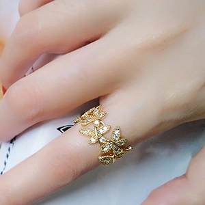 Macro shot of gold leaf-shaped ring with pavé-set zircon leaves for a naturalistic style