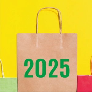 Close-up of 2025 brown kraft paper gift bag with green lettering and rope handles