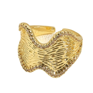 Adjustable golden wave ring featuring micro-pave zircon crystals and textured metal finish