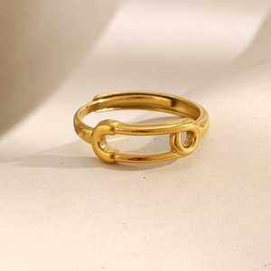 Detail view of the 18K gold-plated safety pin ring with an adjustable open design