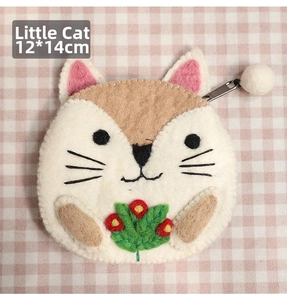 Detail of wool felt cat coin purse with flower embroidery and fluffy ball zipper