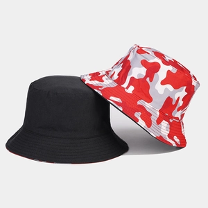 Detail of stacked black and red camouflage reversible bucket hats for sun protection