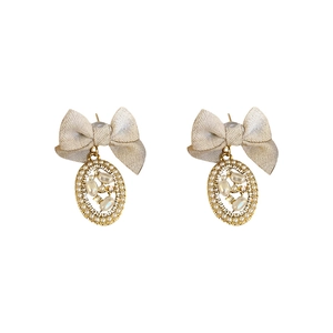 French vintage bow earrings with pearls and rhinestones on a white background