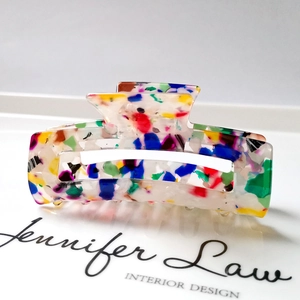 Macro shot of 8.3cm colorful terrazzo acrylic hair claw with minimalist hollow design