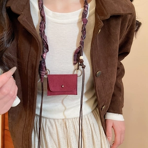 Detail of burgundy suede mini pouch with purple plaid scarf strap and wooden beads