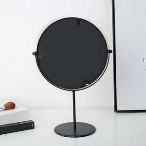 Nordic round desk makeup mirror with minimalist black metal frame on white surface