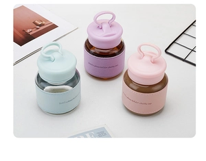 Three glass chubby cups in blue, purple and pink with silicone sleeves on a white desk