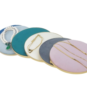 Macro view of velvet jewelry display trays with gold frames for rings and necklaces
