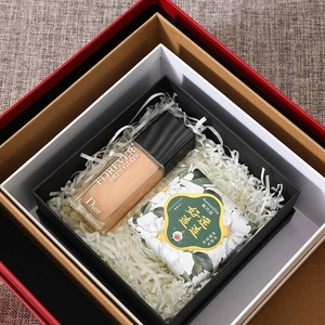 Detailed interior view of a large layered gift box filled with decorative raffia grass