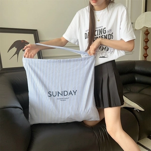 Blue and white striped canvas bag with SUNDAY embroidery shown in a home setting