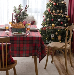 Close-up of red and green plaid Christmas table runner with festive snowflake patterns