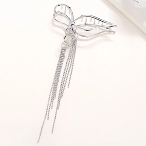 Silver metal shark hair clip featuring hollow bow design and long rhinestone tassels