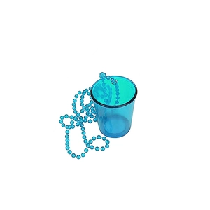 Close-up of a blue transparent plastic shot glass on a bead chain for party celebrations