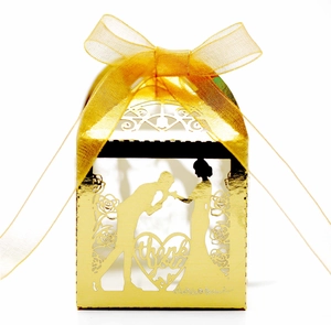 Close-up of gold hollow heart wedding favor box with Thank You laser cut and silk ribbon