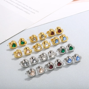 Detailed shot of gold and silver heart studs with colorful crystal stones and OT buckle
