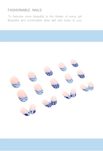 Detail view of oval press-on nails with blue polka dots and sea salt stripes design