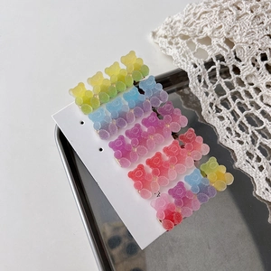 Set of colorful gradient gummy bear hair clips in candy colors on a metal tray