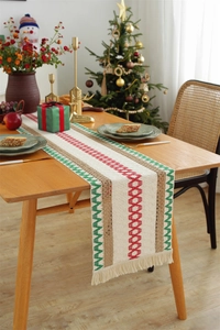 Detailed texture of cotton linen Christmas table runner with tassels and geometric patterns