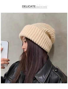 Detail showing high-quality knit texture of a cozy beige winter beanie on a model