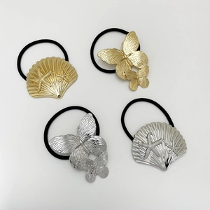 Set of four metal shell and butterfly hair ties in gold and silver on black elastic bands