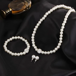 Elegant 3-piece faux pearl jewelry set with sparkling silver accents on black silk