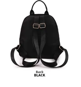 Rear view of black waterproof nylon backpack with adjustable straps and gold metal buckles