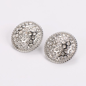 Macro detail of silver round stud earrings with sparkling pave-set crystal rhinestones