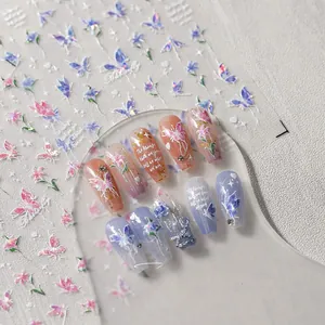 Macro detail of laser iridescent butterfly and floral nail stickers on gradient press-on nails