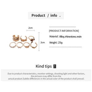 Detailed spec view of 7-piece gold alloy ring set with rhinestone and resin accents