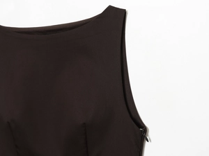 Detailed close-up of dark brown sleeveless dress showing invisible side zipper and stitching