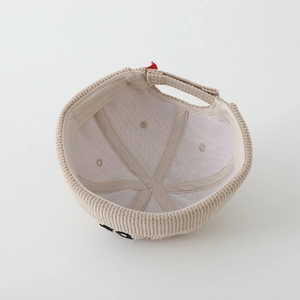 Detail of corduroy docker hat interior showing lining, sweatband and adjustable strap