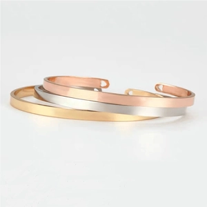 Minimalist open bangles in gold, silver, and rose gold with a polished mirror finish