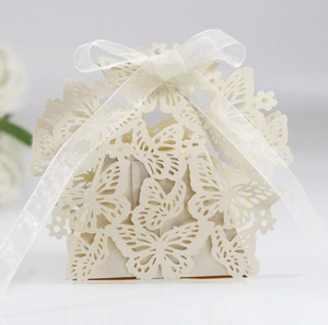 Detail of laser-cut butterfly candy box in pearlescent paper with white ribbon bow