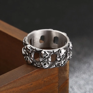 Retro punk skull relief ring in vintage silver finish on a wooden box background
