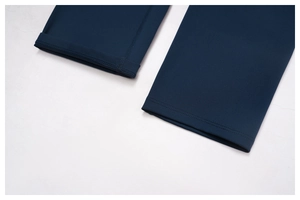 Close-up of double-stitched hem and elastic fabric texture on navy yoga shorts
