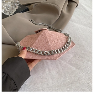 Detailed view of pink hexagonal lace clutch with elegant silver metal chain strap
