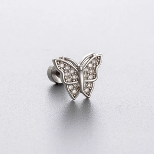 Silver butterfly ear stud with sparkling zircon stones on a gray matte background