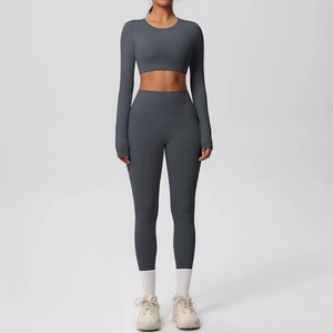 Detail of high-stretch seamless charcoal yoga set featuring cropped long sleeve top and leggings