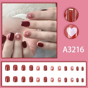 Short square press-on nails with wine red blush gradient and white heart patterns