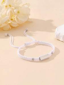 White hand-woven adjustable bracelet with silver metal plate and decorative beads