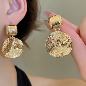 Fashionable gold-plated drop earrings featuring hammered texture round pendants