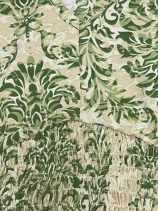 Close-up of tropical floral print fabric with elastic smocked waist and fine stitching